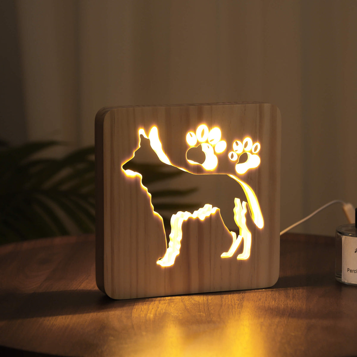 Side view of the glowing German Shepherd night light in a dark room