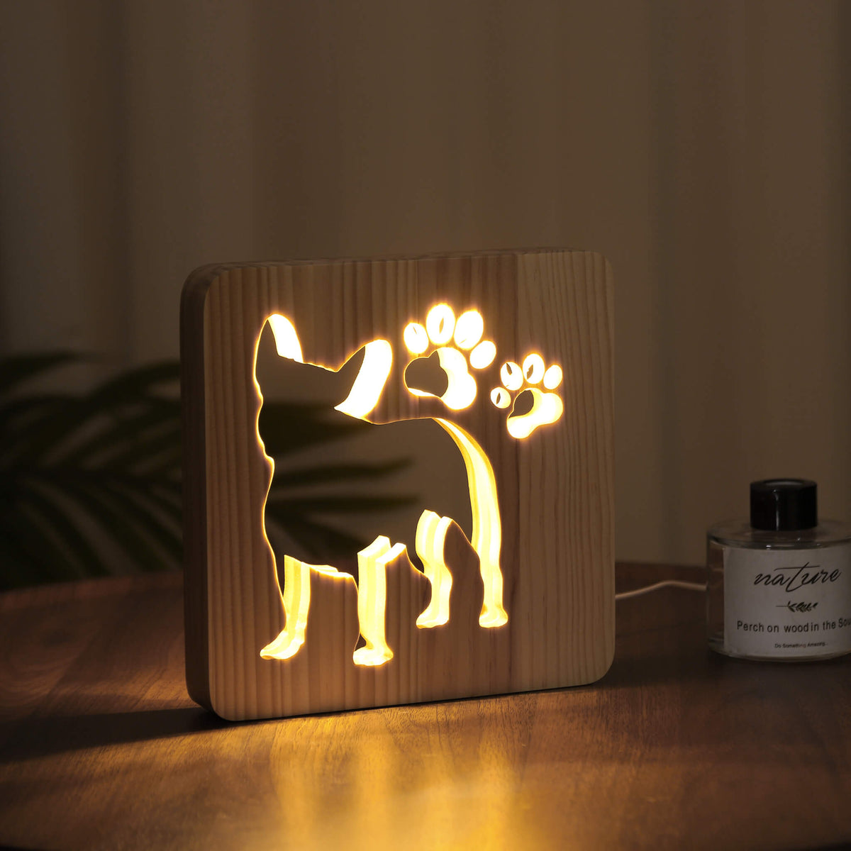 Glowing Frenchie night light in a dark room, viewed from an angle