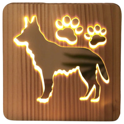 Close-up of the carved German Shepherd and paw prints on the wooden night light