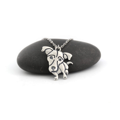Jack Russell silver charm displayed on black pebble
