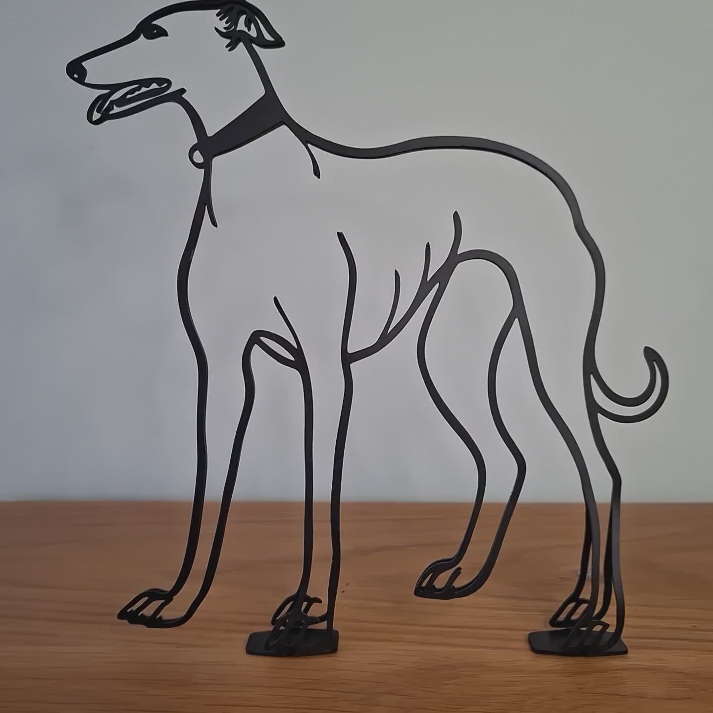 video panning around a greyhound minimalist metal statue 