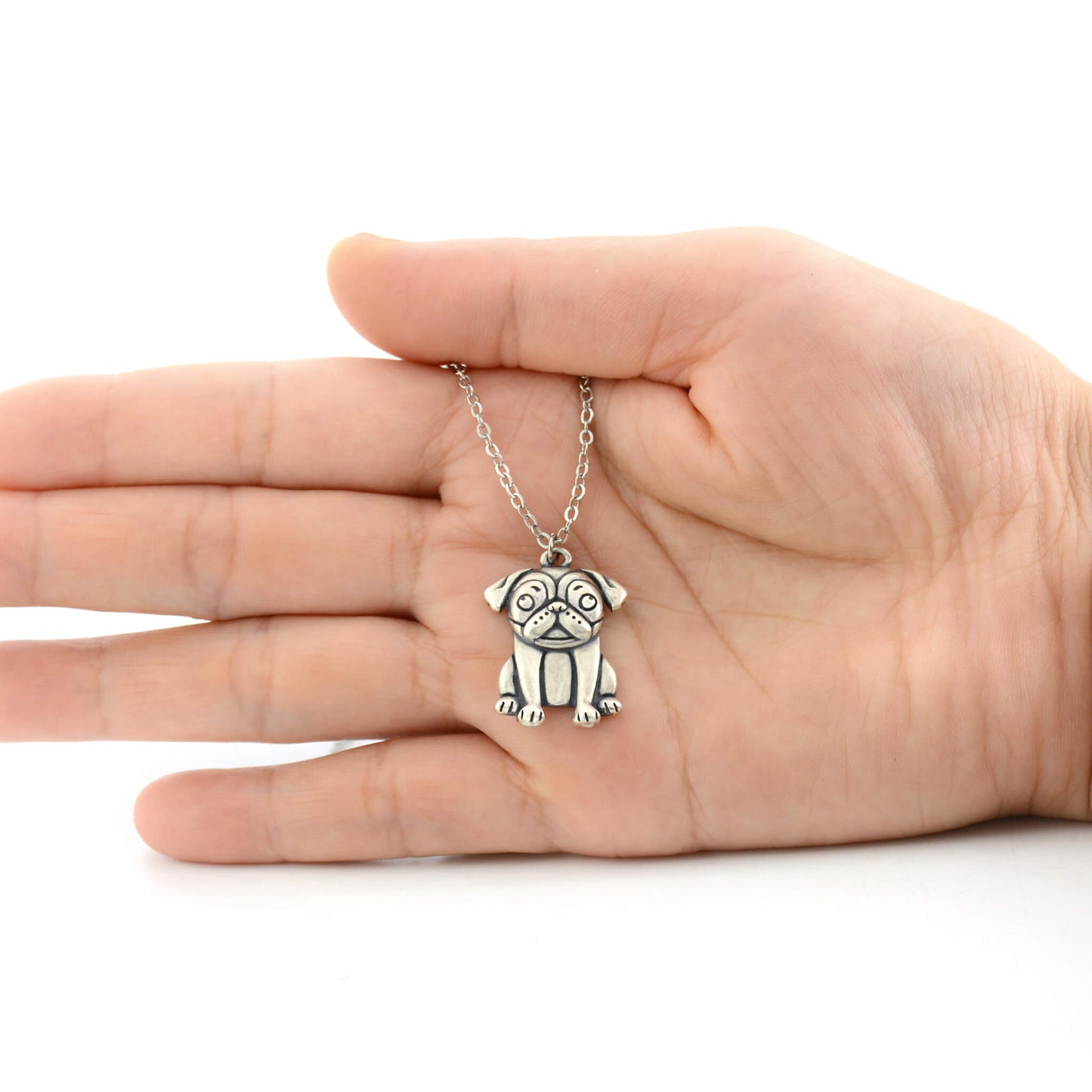 925 silver pug charm size displayed on hand