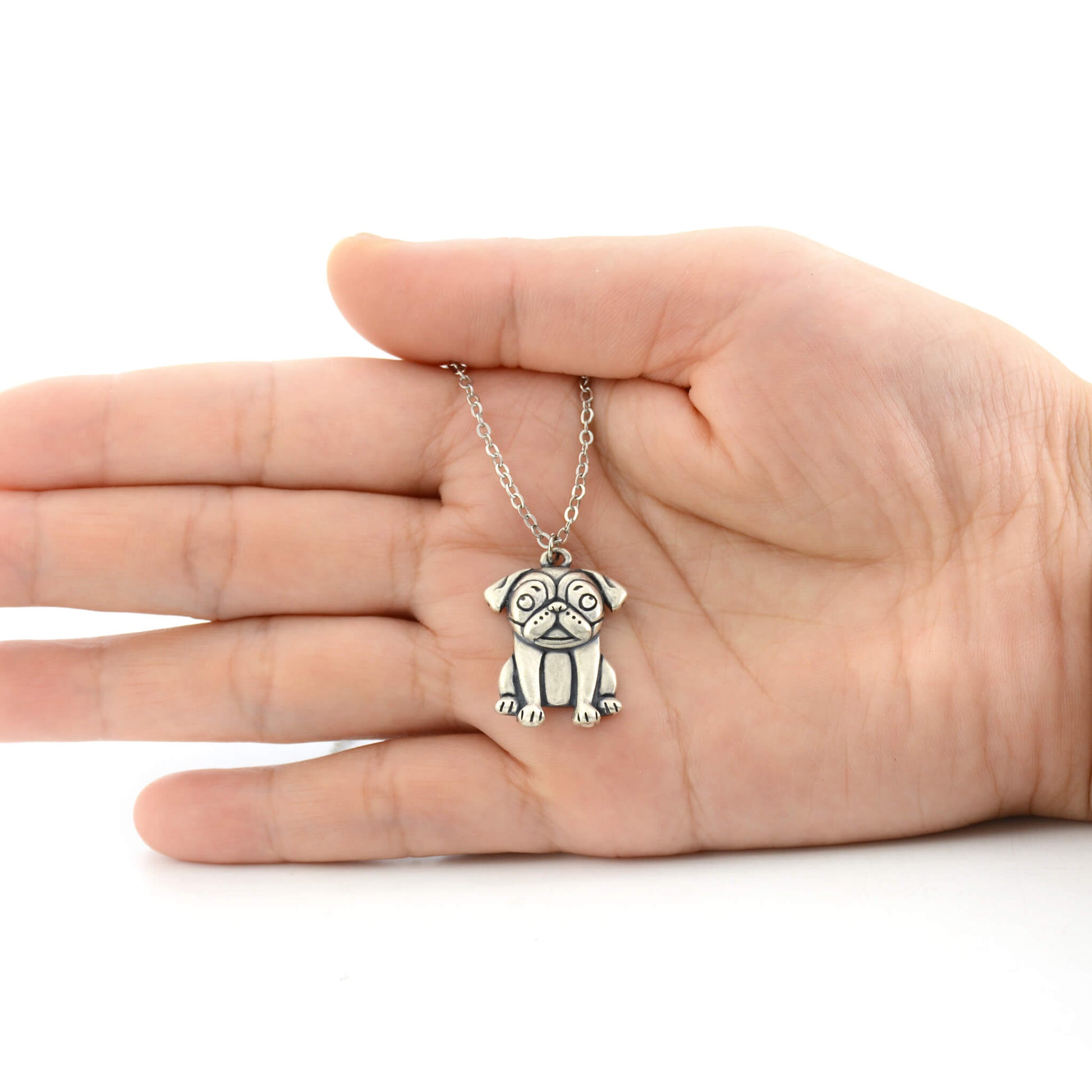 925 silver pug charm size displayed on hand