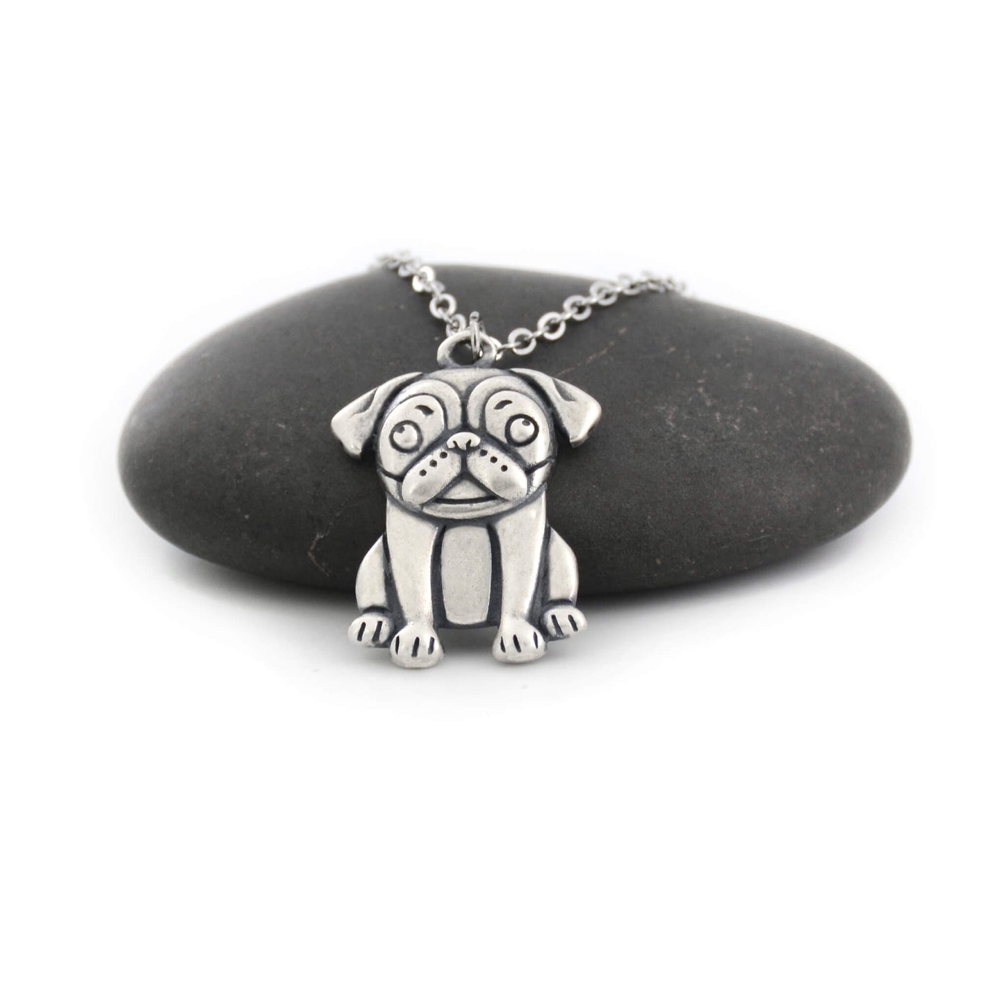 silver pug charm chain displayed on black pebble