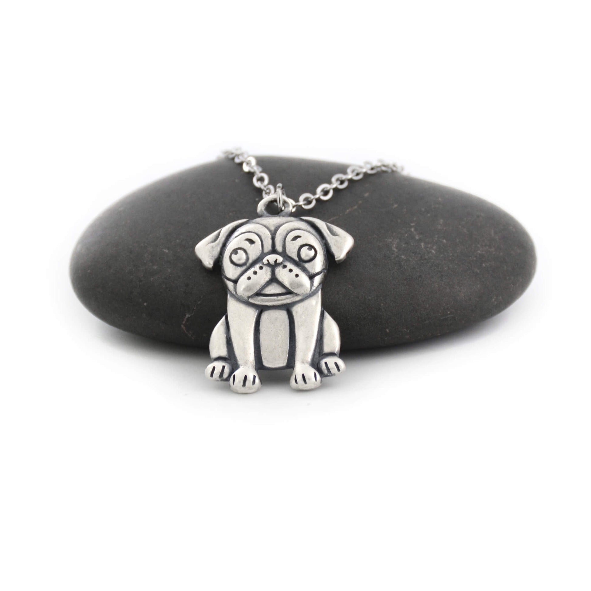 silver pug charm chain displayed on black pebble