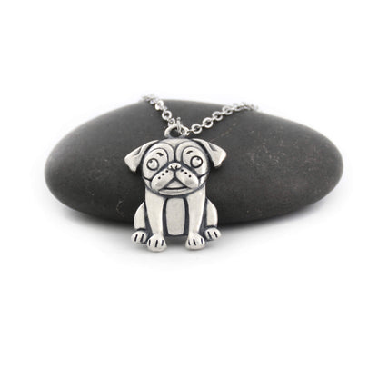 silver pug charm chain displayed on black pebble