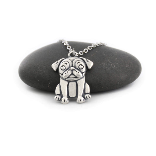 silver pug charm chain displayed on black pebble