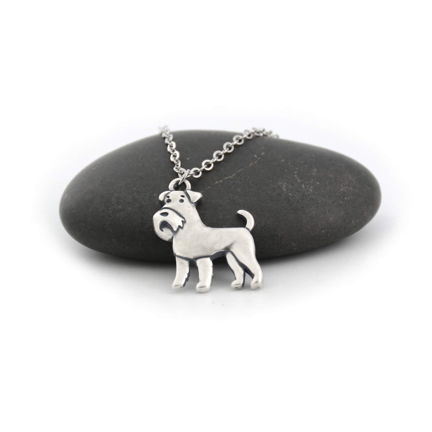 silver schnauzer charm necklace displayed on black pebble