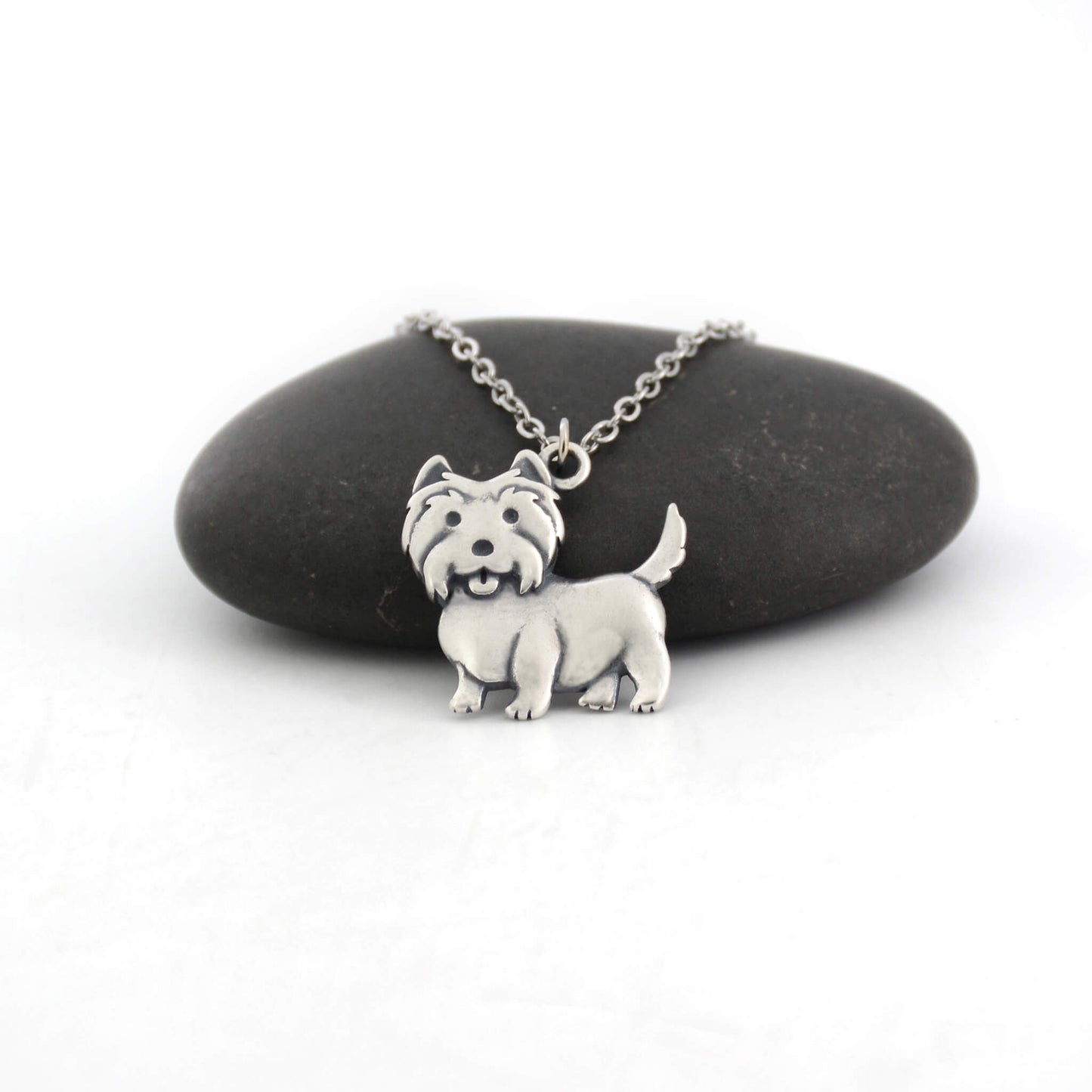 west highland terrier silver charm displayed on black pebble