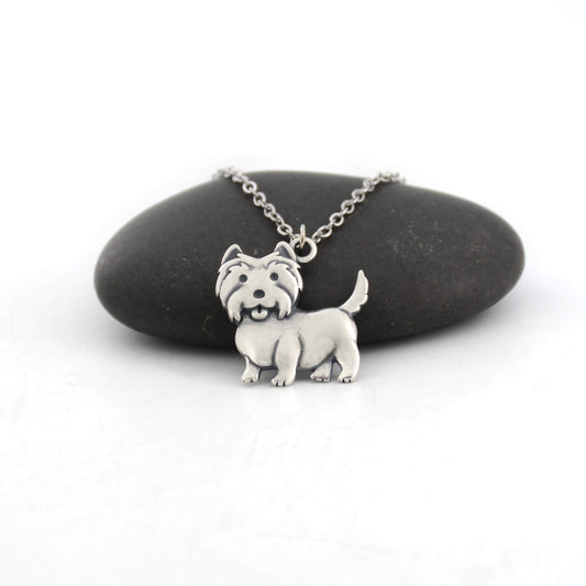 west highland terrier silver charm displayed on black pebble