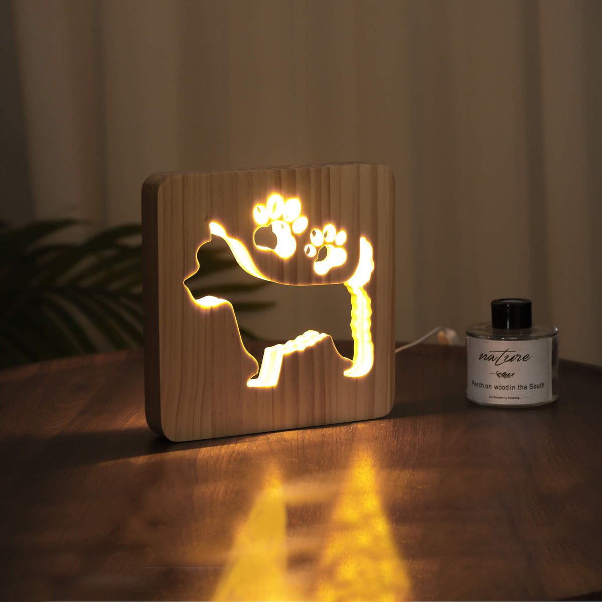 Westie night light lit up in a dark room, casting a soft warm glow