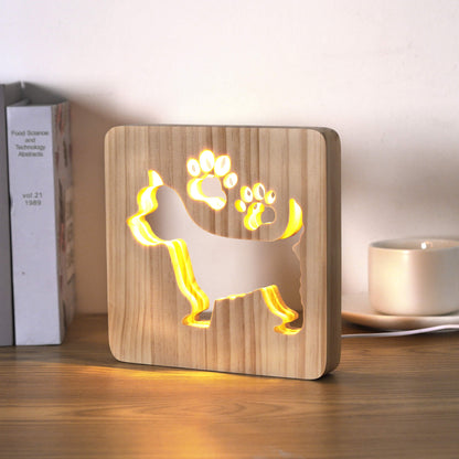 Westie wooden lamp glowing on a desk, viewed from a slight angle